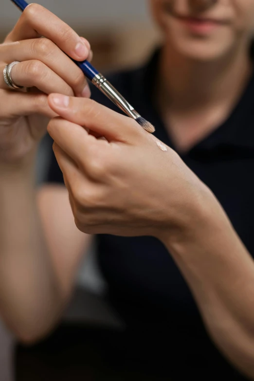 a woman getting her nails done by a hair stylist, trending on reddit, photorealism, holding a paintbrush in his hand, synthetic bio skin, ready to model, paul barson