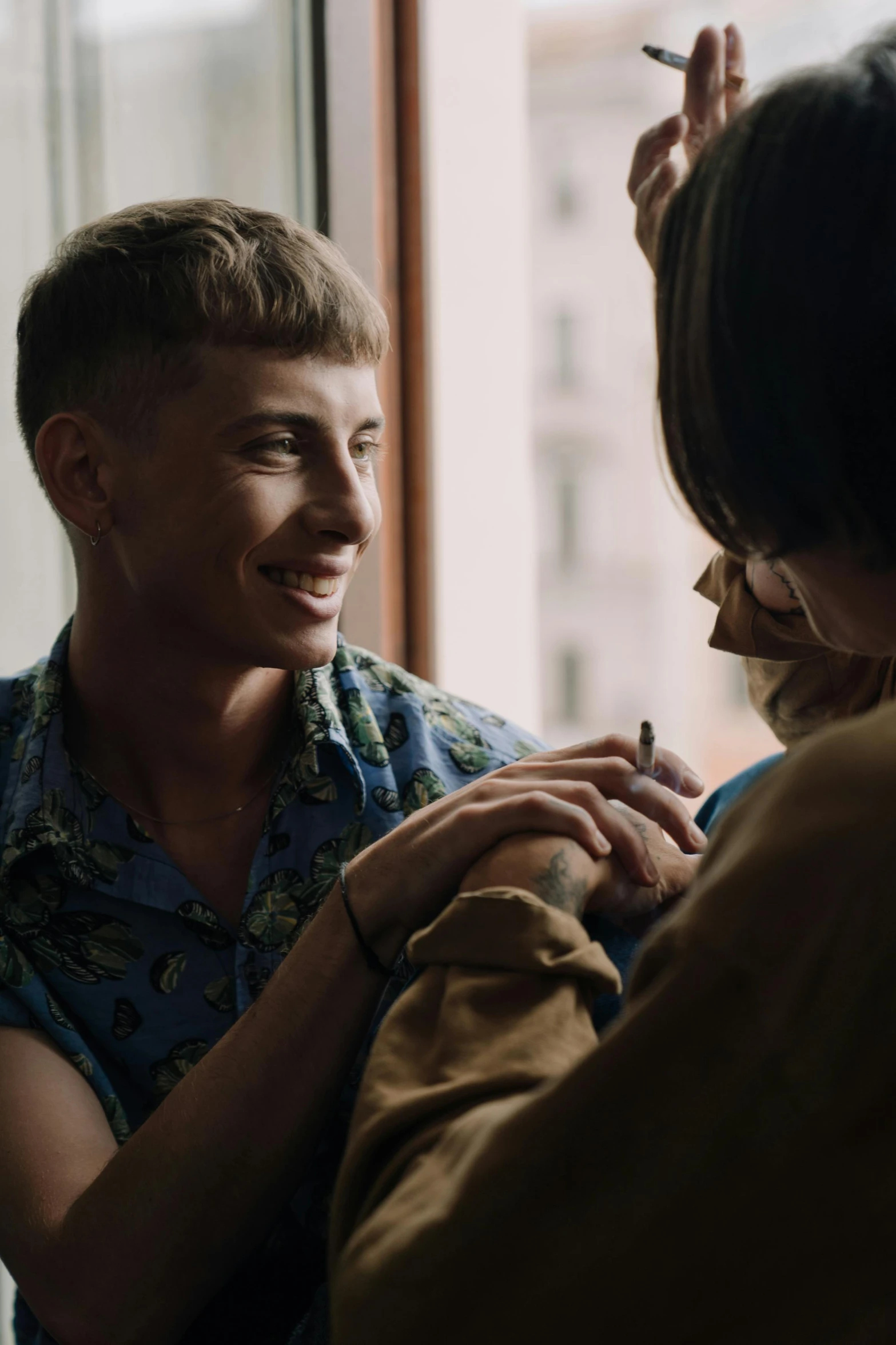 a woman combing a man's hair in front of a window, a tattoo, trending on reddit, lesbian embrace, wide film still, ignant, holding hands