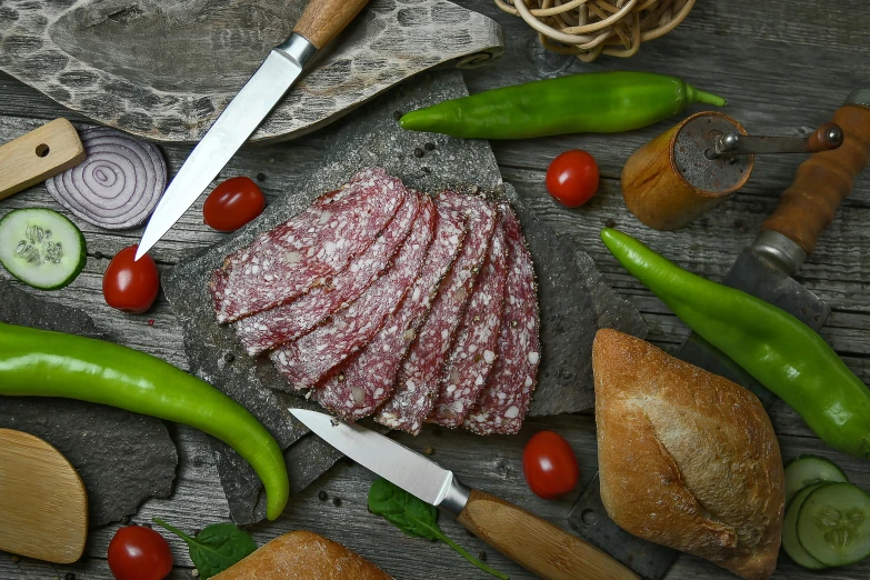 a table topped with lots of different types of food, by Matthias Stom, pexels contest winner, art nouveau, salami, background image, grey, full body close-up shot