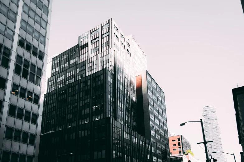 a black and white photo of a tall building, pexels contest winner, sunfaded, montreal, red - yellow - blue building, office building