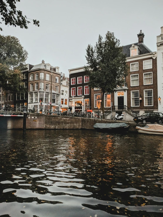 a group of boats floating on top of a river, by Jan Tengnagel, pexels contest winner, happening, gothic city streets behind her, dutch houses along a river, highly detailed in 4k”, bright ”