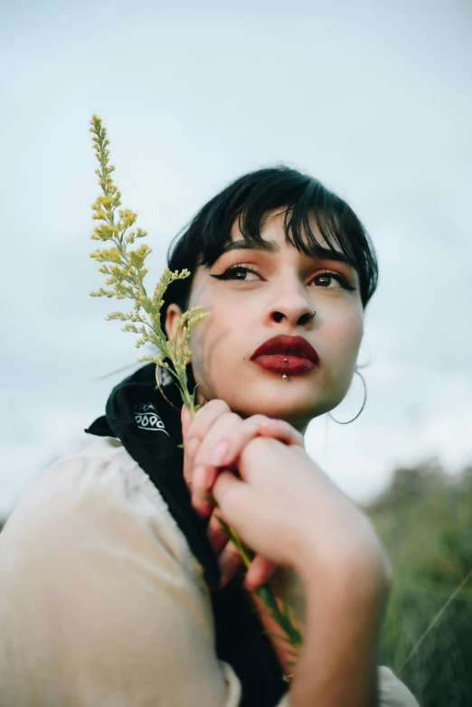 a woman with a flower in her hand, an album cover, trending on pexels, pouty lips, non binary model, manuka, thick red lips