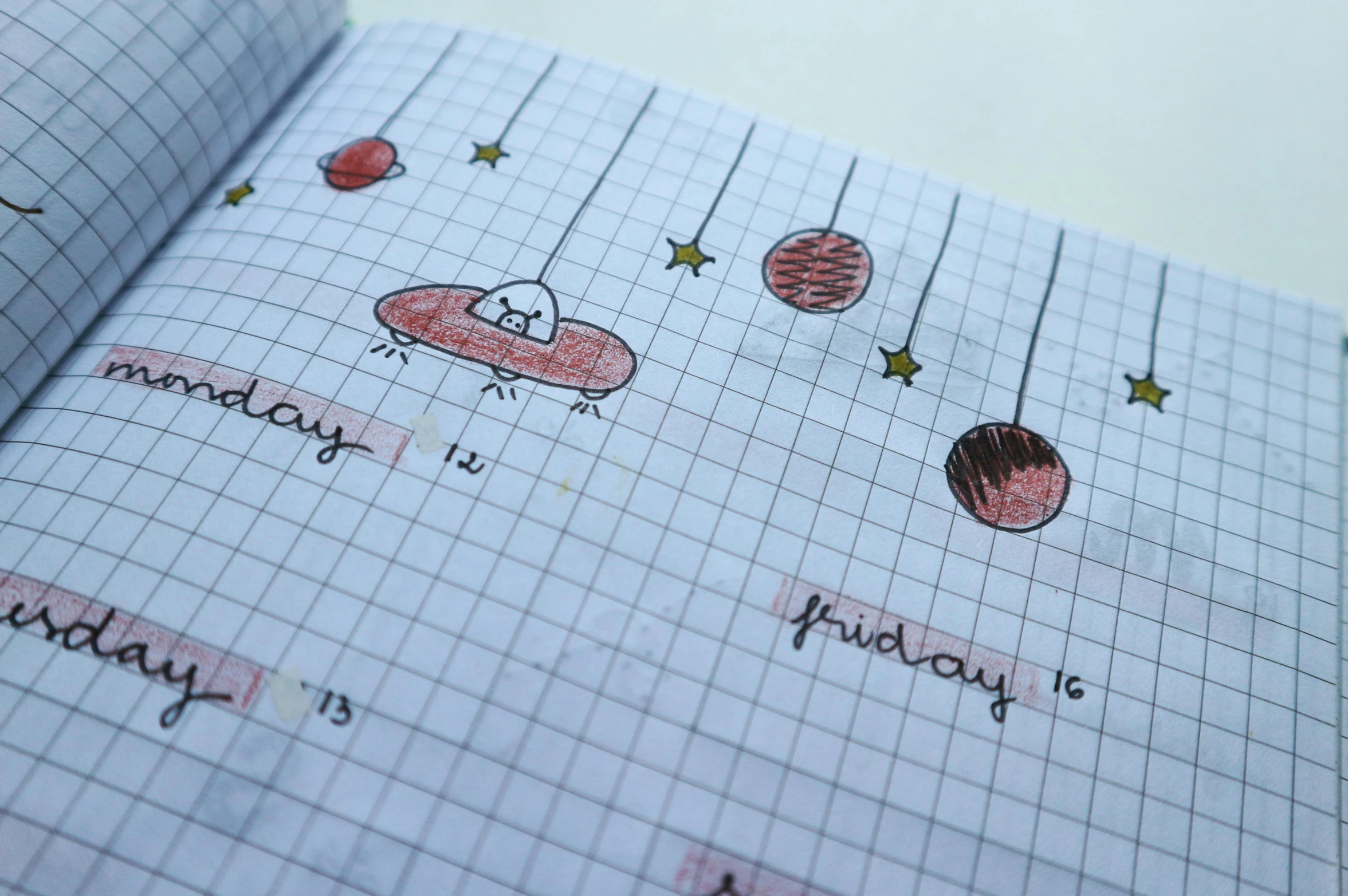 a close up of a notebook with drawings on it, by Emma Andijewska, pexels, on a spaceship, good day, red grid, tiny stars