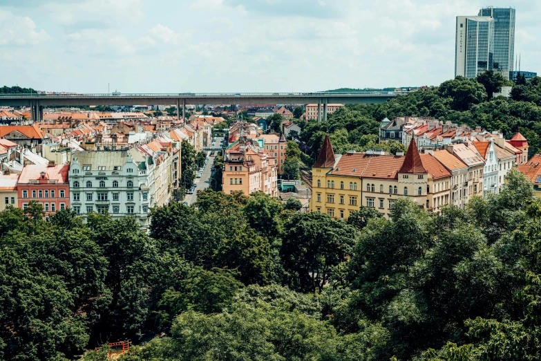 a view of a city from the top of a hill, by Emma Andijewska, square, greenery, munkácsy, conde nast traveler photo