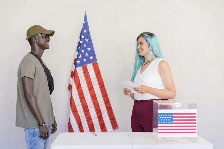 a man and a woman standing in front of an american flag, pexels contest winner, on a pedestal, varying ethnicities, cardboard cutout, vine