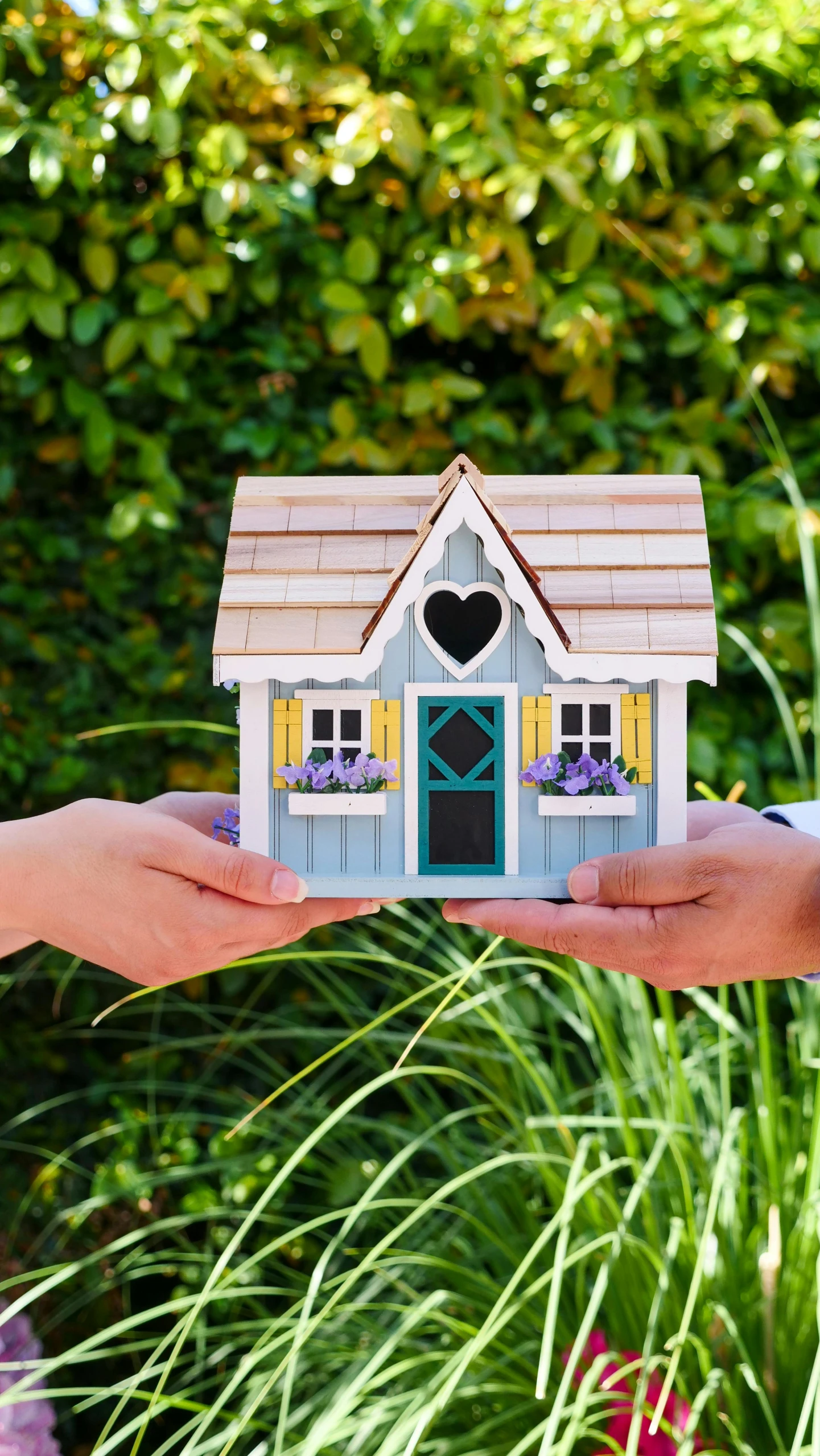 a person holding a small house in their hands, by Arabella Rankin, unsplash, square, fully decorated, wooden cottage, high quality photo