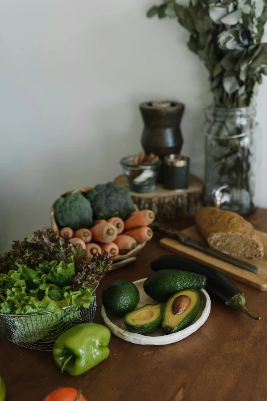 a wooden table topped with assorted fruits and vegetables, avocados, home display, environmental shot, botanical