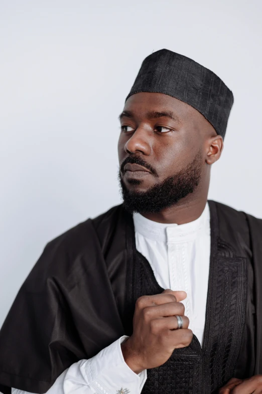 a man wearing a black robe and a white shirt, inspired by Ras Akyem, trending on pexels, les nabis, wearing dark grey suit, black pointed hat, a handsome man，black short hair, giga chad