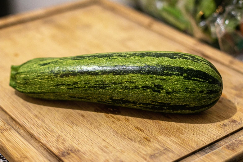 a zucchini sitting on top of a wooden cutting board, inspired by Géza Dósa, unsplash, renaissance, square, made of glazed, large cornicione, panorama