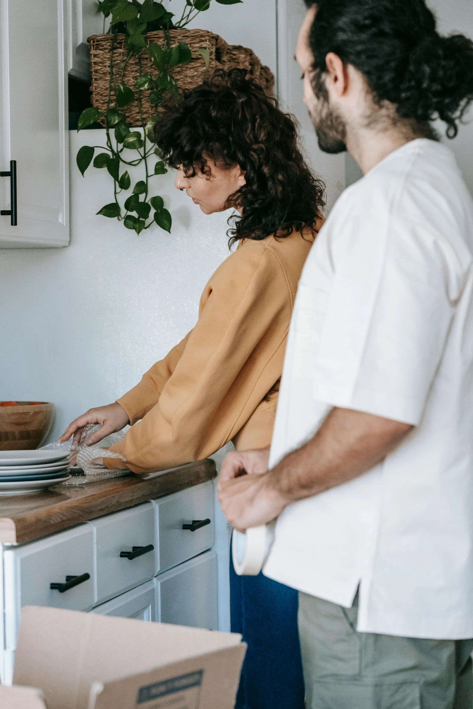 a man and woman standing in a kitchen preparing food, by Elizabeth Durack, pexels contest winner, plates, clean minimalist design, gif, casually dressed