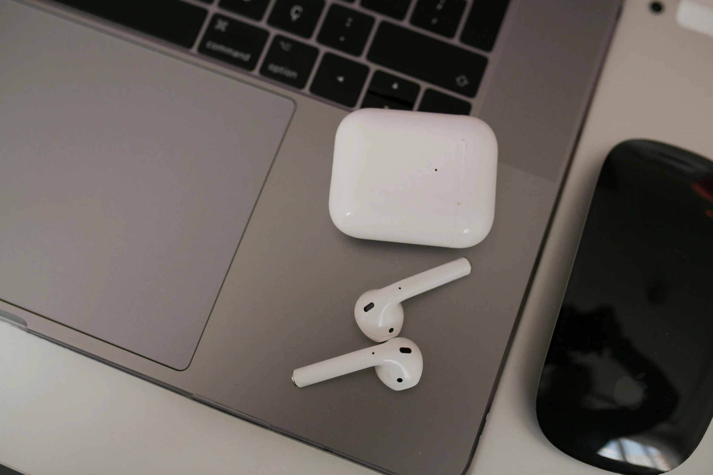 an apple airpods sitting on top of a laptop computer, by Carey Morris, pexels, square, floating headsets, white, bone