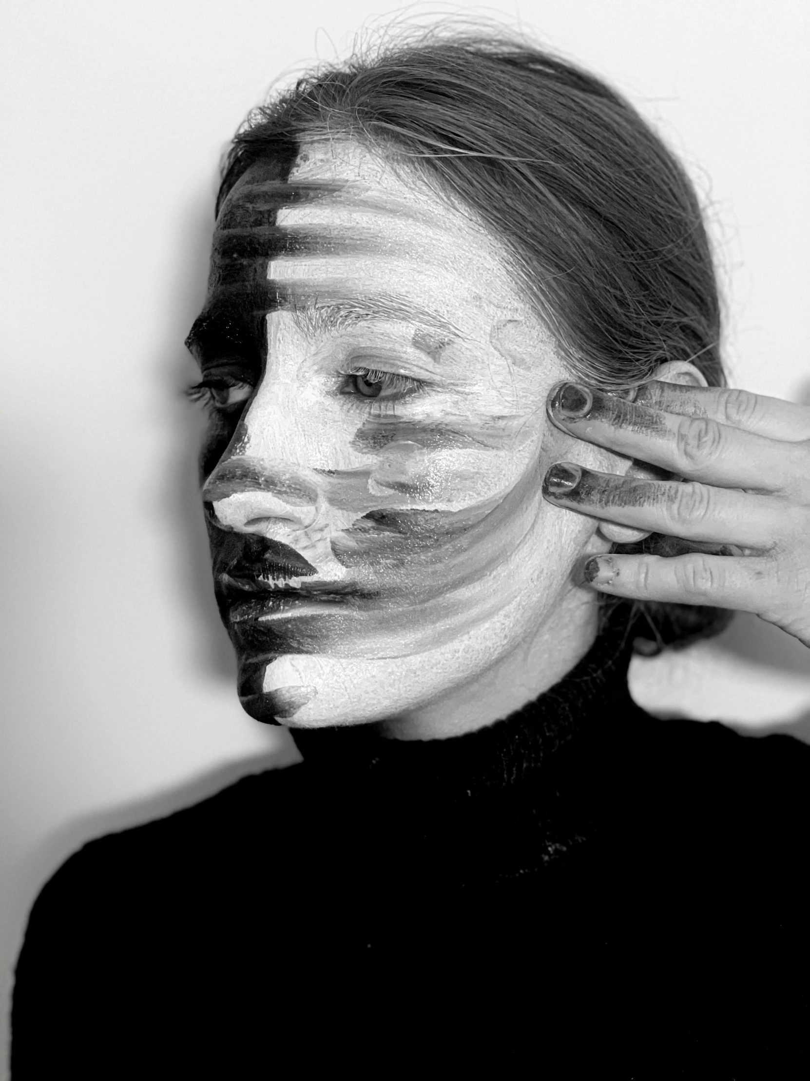 a black and white photo of a woman with white paint on her face, a hyperrealistic painting, inspired by Grete Stern, unsplash, faceless, petra collins and mc. escher, with differing emotions, alina ivanchenko