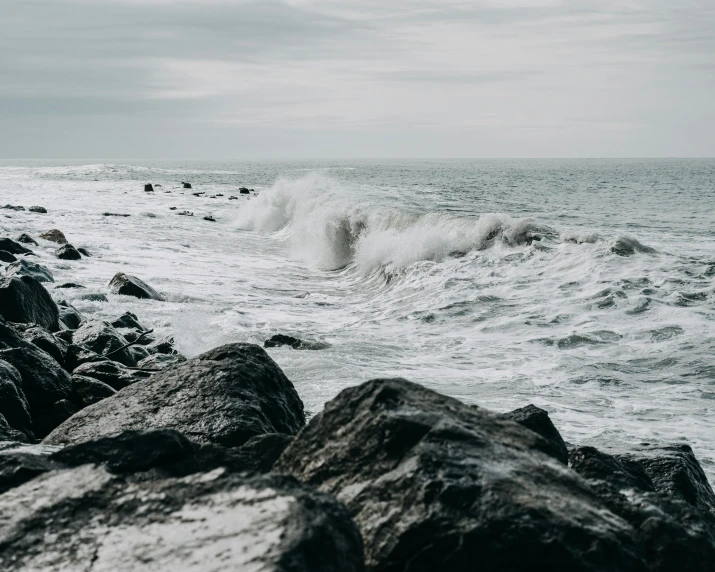 a black and white photo of the ocean, pexels contest winner, waves crashing at rocks, background image, high quality wallpaper, seaside