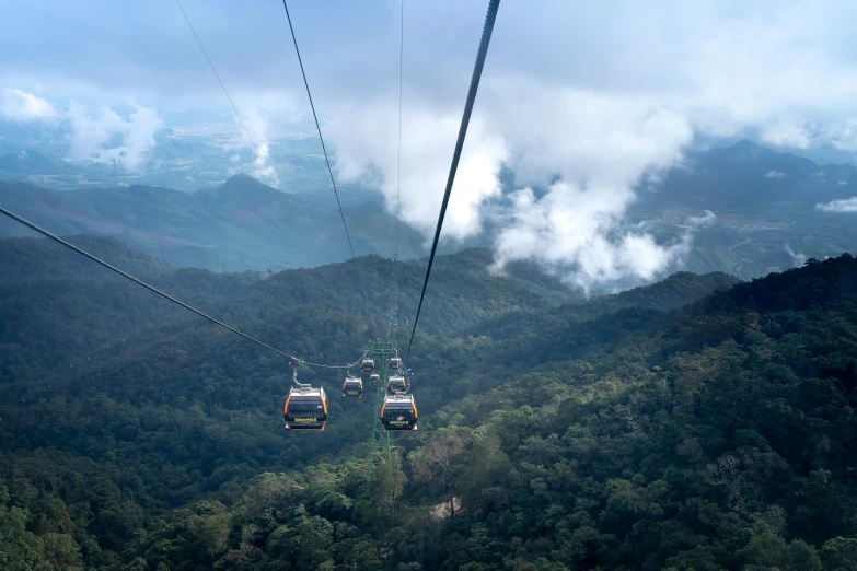 a couple of gondolas sitting on top of a mountain, by Matthias Stom, pexels contest winner, sumatraism, avatar image, cables hanging, flying above a tropical forest, thumbnail