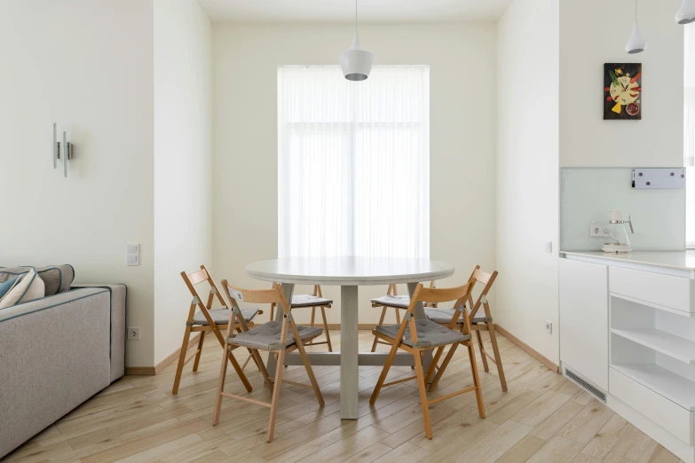 a living room filled with furniture and a dining table, inspired by Constantin Hansen, pexels contest winner, light and space, minimal kitchen, round format, vladimir krisetskiy, located in hajibektash complex