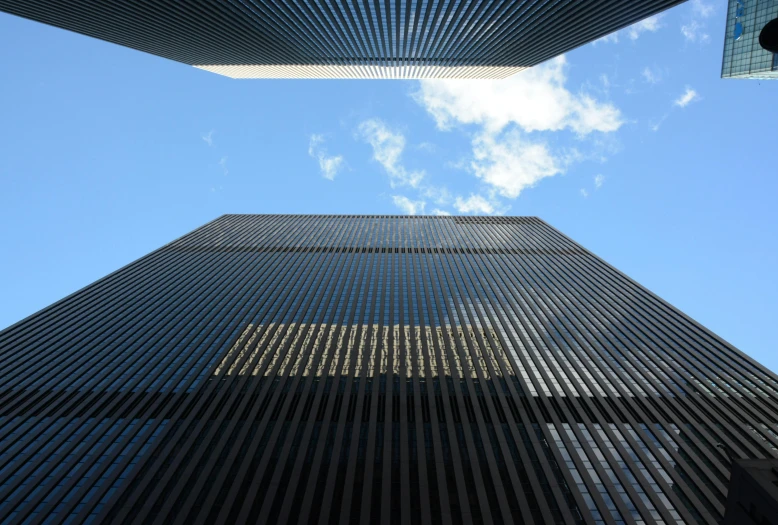 a couple of tall buildings that are next to each other, an album cover, by Robert Jacobsen, pexels contest winner, modernism, black steel buildings, new york buildings, square lines
