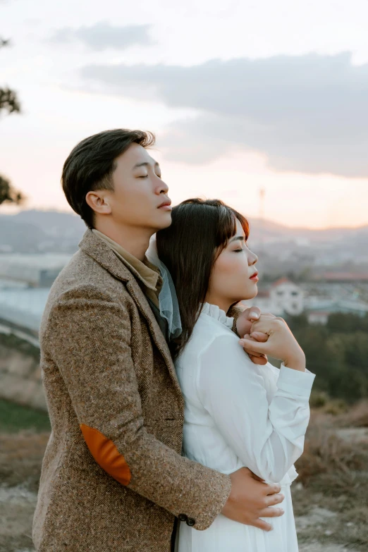 a man and a woman standing next to each other, by Jang Seung-eop, pexels contest winner, romanticism, hills in the background, ulzzang, square, tyler edlin and natasha tan