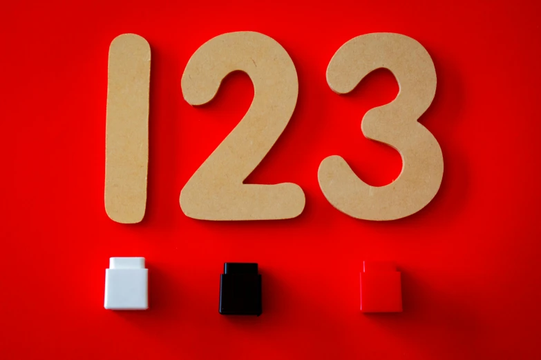 a close up of a number on a red background, by Julia Pishtar, unsplash, square shapes, 1 3 3 4 building, as 3 figures, 1.2