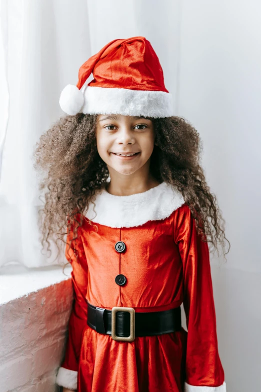 a little girl wearing a santa claus costume, a black man with long curly hair, full product shot, thumbnail, girl standing