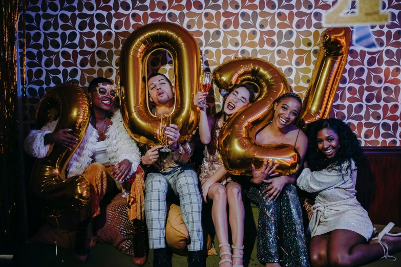 a group of women sitting next to each other holding gold balloons, trending on pexels, happening, 2 2 years old, doja cat, 30 year old man, 🐿🍸🍋