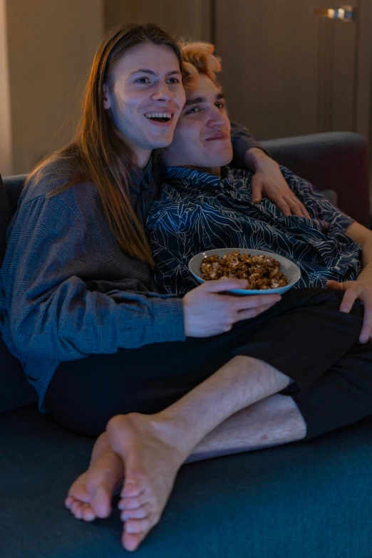 a man and woman sitting on a couch watching tv, inspired by Nan Goldin, trending on reddit, renaissance, bowl filled with food, cereal, high-quality photo, full body close-up shot