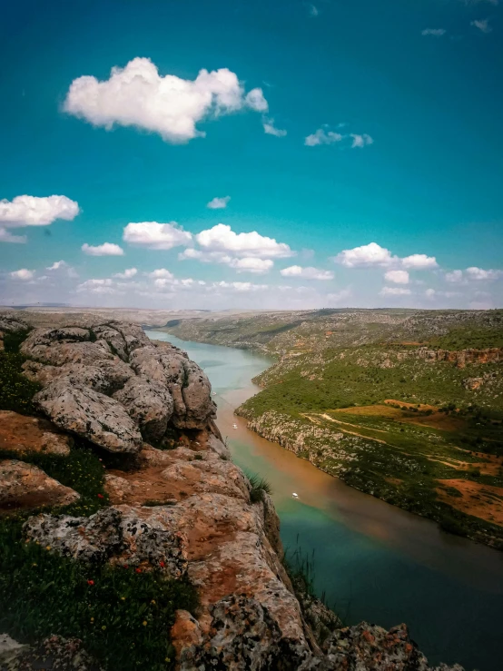 a river running through a lush green valley, an album cover, by Ibrahim Kodra, pexels contest winner, hurufiyya, panoramic view, cliff side, instagram story, today\'s featured photograph 4k