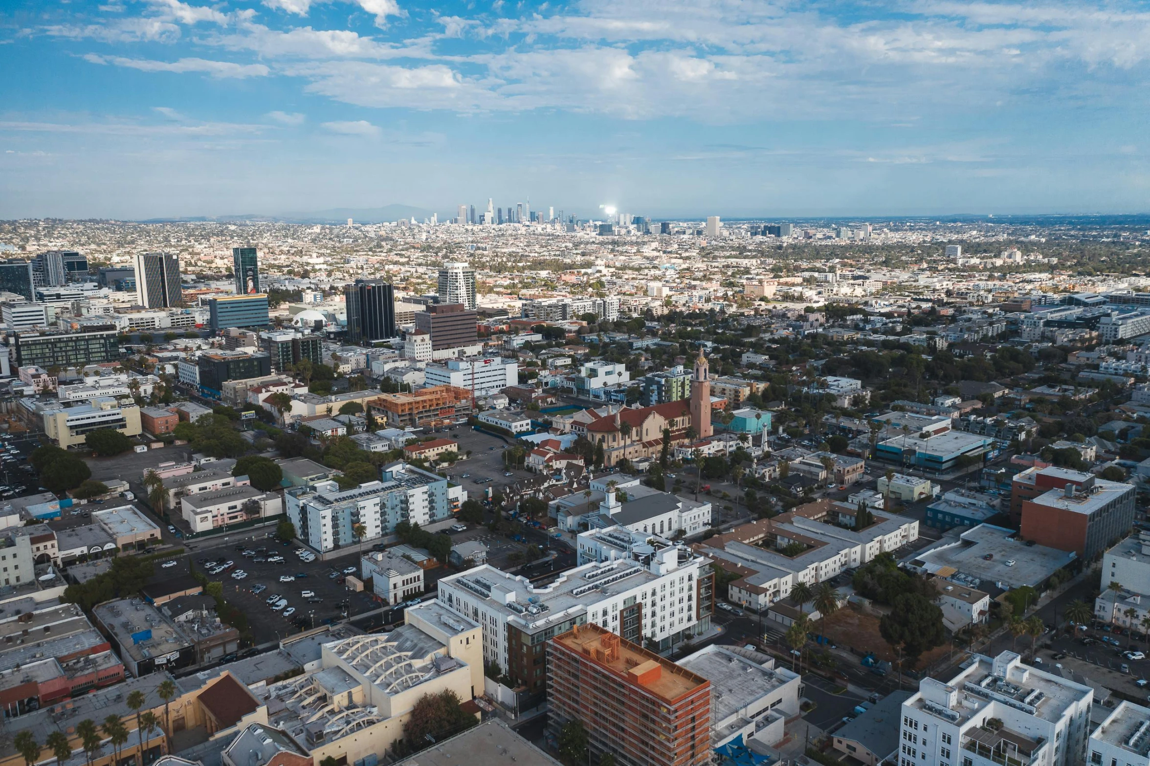 an aerial view of a city with tall buildings, by Carey Morris, unsplash contest winner, visual art, mulholland drive, background image, full daylight, taken in the early 2020s