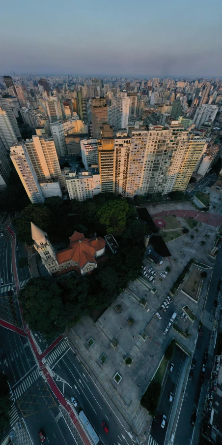 an aerial view of a city at dusk, an album cover, by Felipe Seade, pexels contest winner, photorealism, sao paulo in the year 2 0 7 0, taken on go pro hero8, mossy buildings, 15081959 21121991 01012000 4k