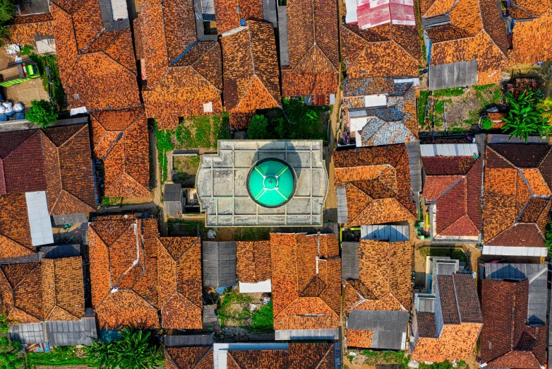 an aerial view of a pool in a residential area, an album cover, by Dan Content, pexels contest winner, renaissance, sri lanka, tiled roofs, fulldome, historical setting