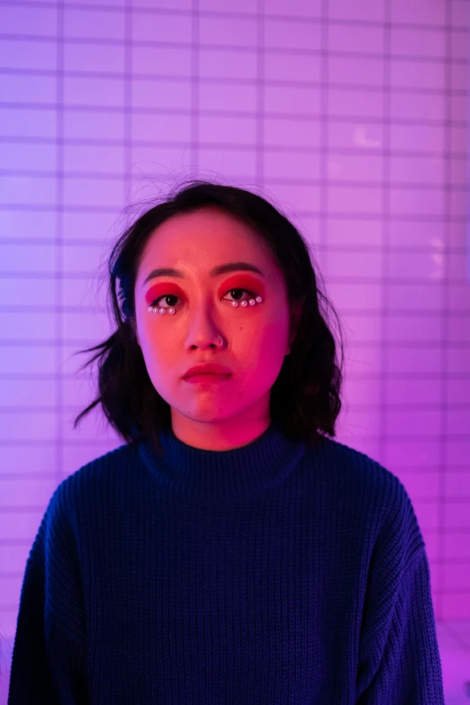 a woman standing in front of a purple light, an album cover, inspired by Ruth Jên, trending on pexels, half asian, big open electric eyes, smol, human face with bright red yes