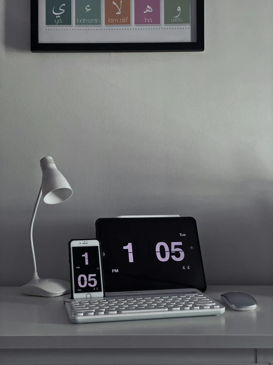 a laptop computer sitting on top of a white desk, clocks, grey and dark theme, experimental studio light, home display