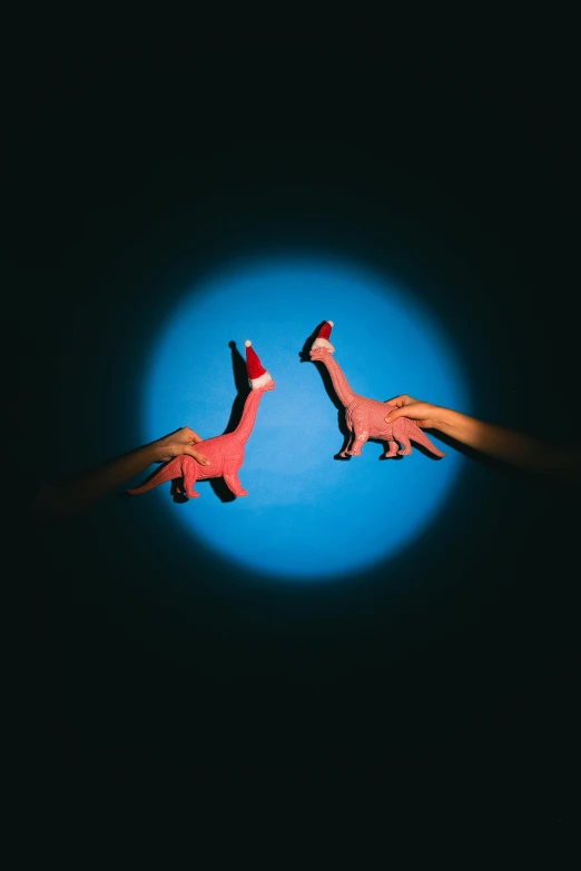 two hands reaching towards each other in the dark, an album cover, by Paul Bird, magic realism, toy photo, dinosaurs, blue or red, two legs