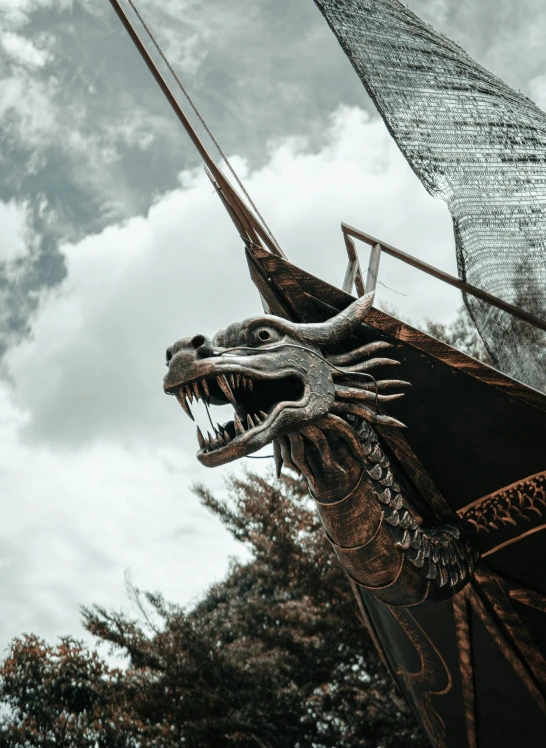 a dragon statue in front of a tall building, a statue, pexels contest winner, viking boat, avatar image, extreme intricate metal details, he's on an old sailing boat
