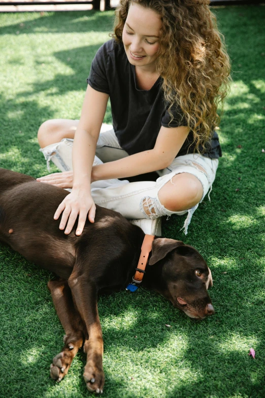 a woman sitting on the grass petting a brown dog, laid - back, full product shot, feature, turf roof