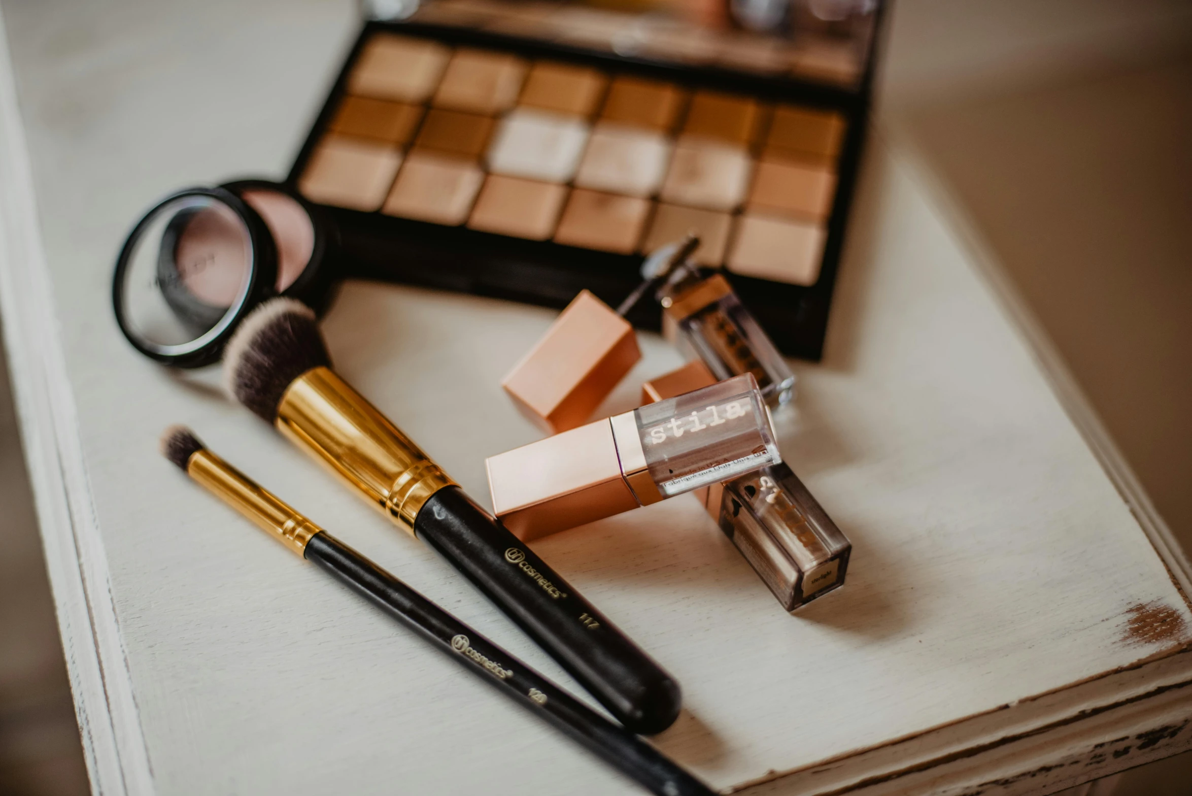 a couple of makeup brushes sitting on top of a table, trending on pexels, brown, modelling, rectangular, with a bunch of stuff