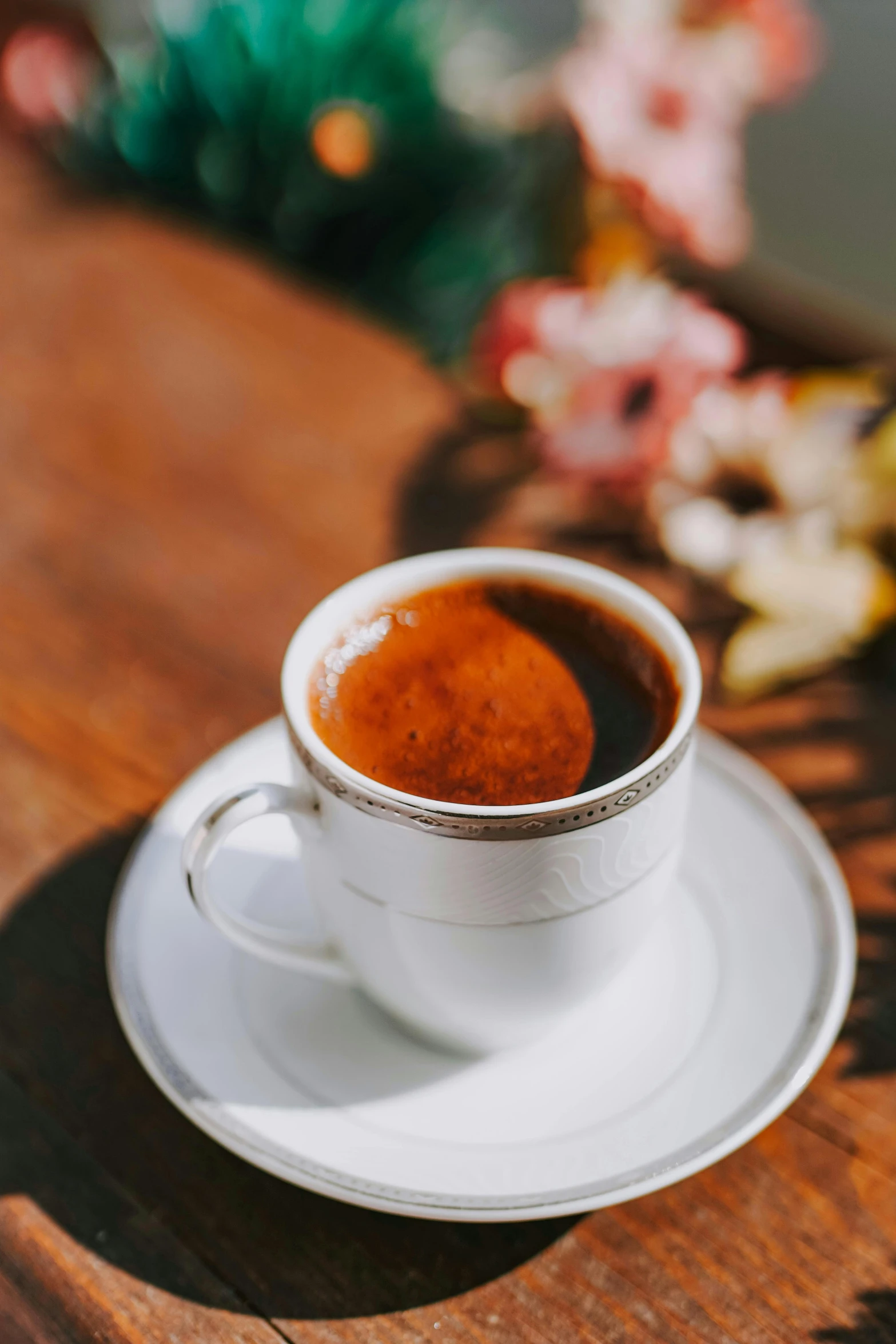 a cup of coffee sitting on top of a wooden table, hurufiyya, displayed, upclose, dark sienna and white, greek