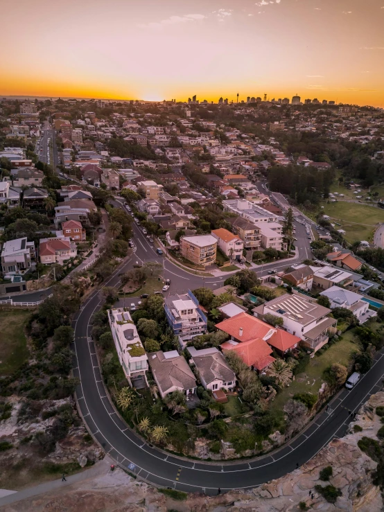 an aerial view of a city at sunset, by Lee Loughridge, pexels contest winner, manly, some houses in the background, 4k panoramic, shot on iphone 1 3 pro max