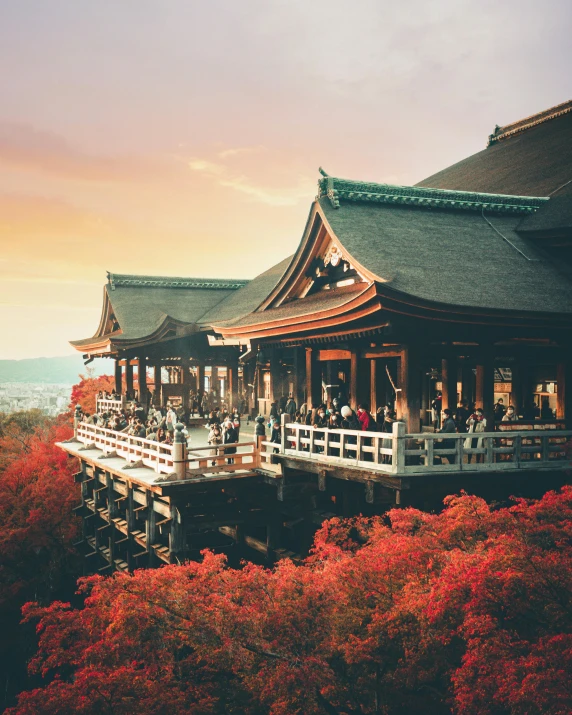 a large building sitting on top of a lush green hillside, by Torii Kiyomasu, unsplash contest winner, ukiyo-e, red leaves, pink golden hour, festival of rich colors, high view