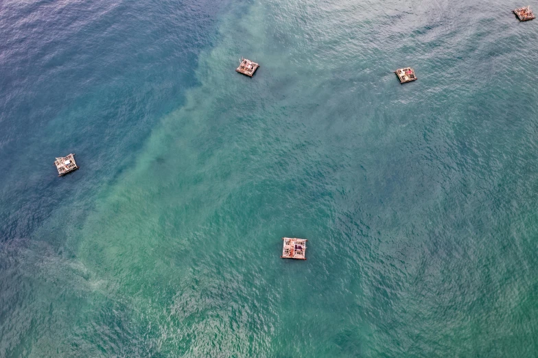 a group of boats floating on top of a body of water, by Jessie Algie, pexels contest winner, conceptual art, waikiki beach, 2 5 6 x 2 5 6 pixels, dredged seabed, surface hives