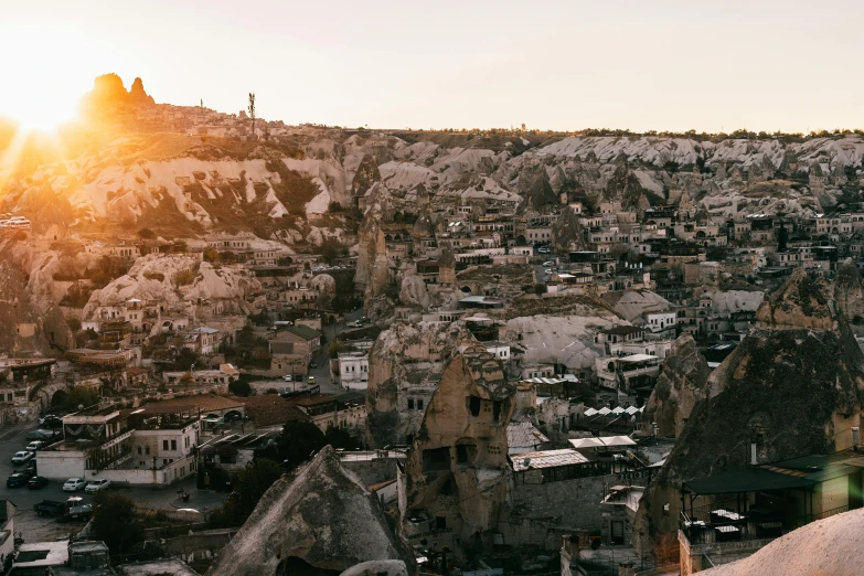 a view of a city from the top of a hill, pexels contest winner, hurufiyya, buildings carved out of stone, late afternoon sun, aykut aydogdu, 2 0 0 0's photo