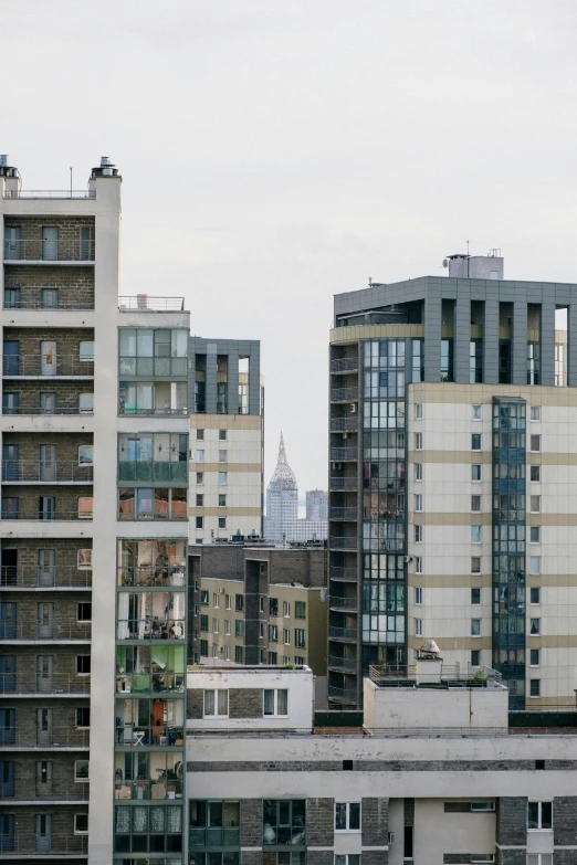 a couple of tall buildings sitting next to each other, by Carey Morris, unsplash, modernism, harlem, viewed from a distance, ignant, 2022 photograph