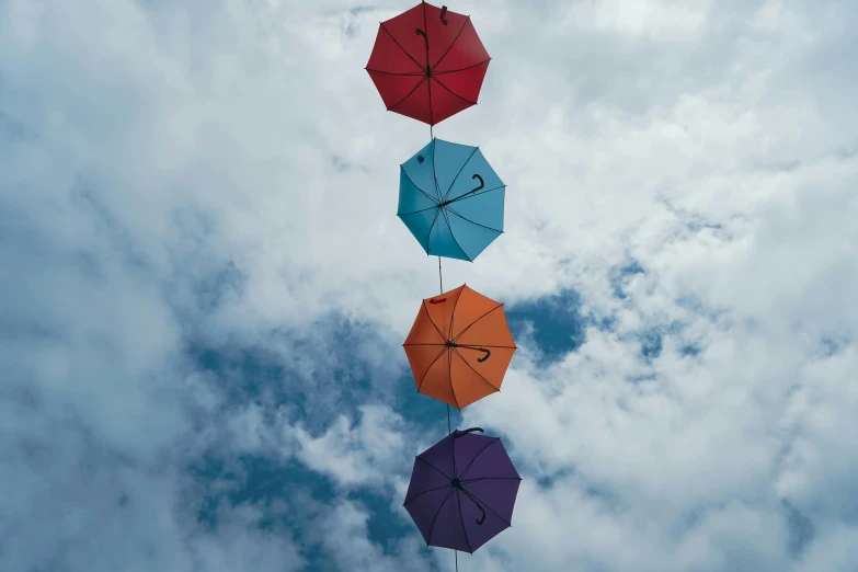 a bunch of umbrellas that are hanging in the air, inspired by Storm Thorgerson, pexels contest winner, conceptual art, light blue sky with clouds, avatar image, four stories high, teal and orange colours