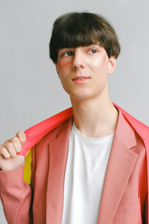 a young man wearing a pink blazer and a white t - shirt, an album cover, pexels contest winner, andrea savchenko, wearing red and yellow clothes, genderless, with a fringe