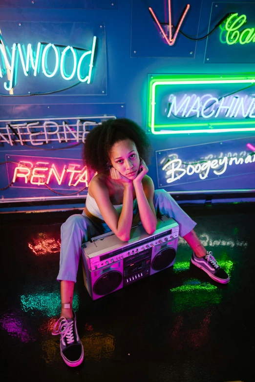 a woman sitting on the ground in front of neon signs, trending on pexels, boombox, nathalie emmanuel, neon glowing wood, girl in studio