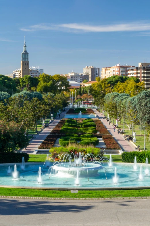 a large fountain in the middle of a park, inspired by Luis Paret y Alcazar, shutterstock, skyline showing, square, 15081959 21121991 01012000 4k, city views