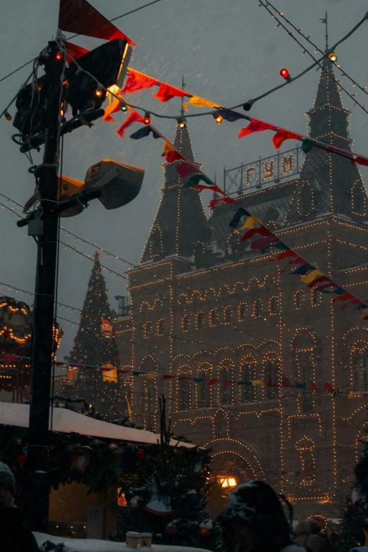 a group of people that are standing in the snow, inspired by Vasily Surikov, unsplash contest winner, christmas lights, soviet architecture, profile image, flags