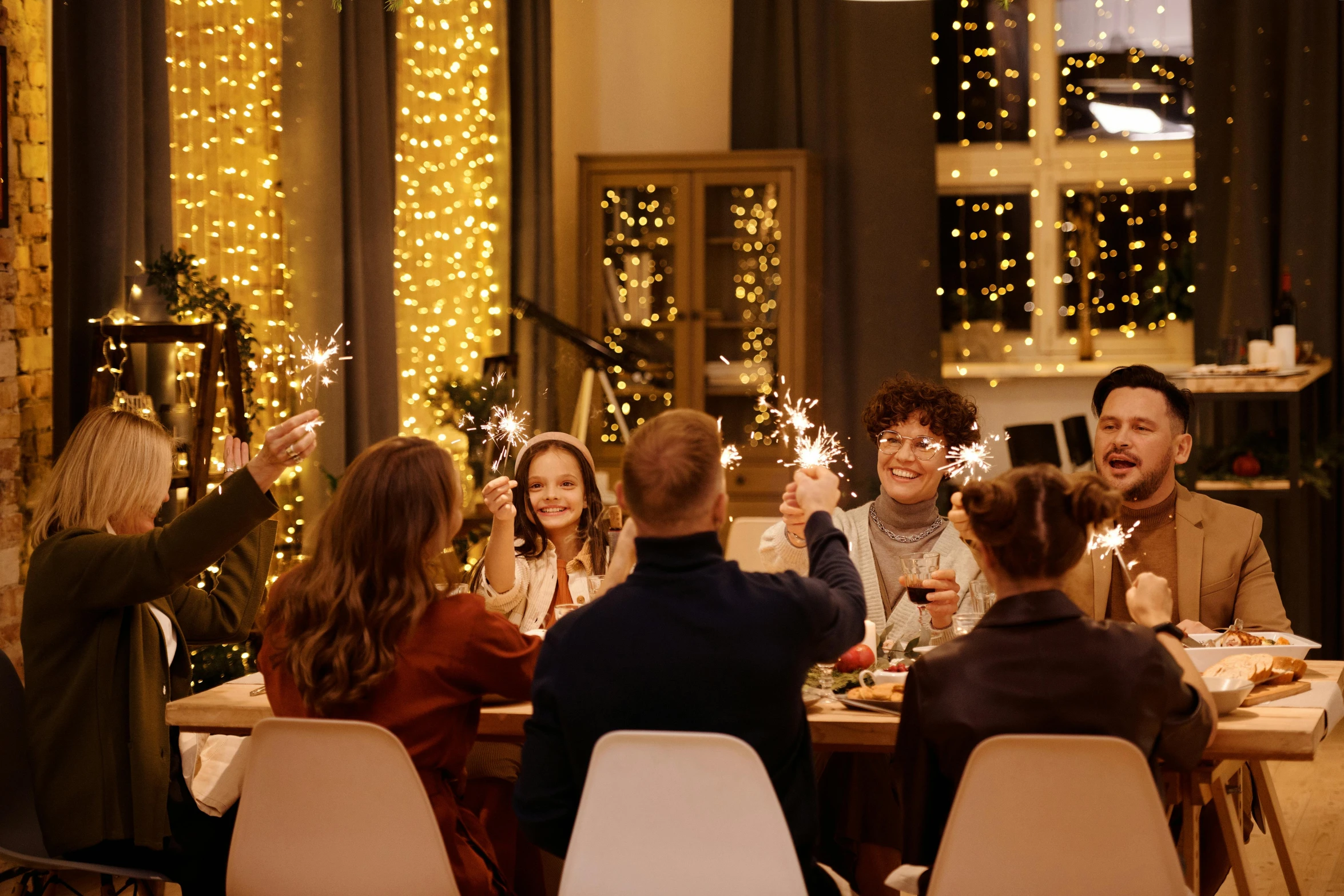 a group of people sitting around a table with sparklers, christmas, medium height, fan favorite, designer