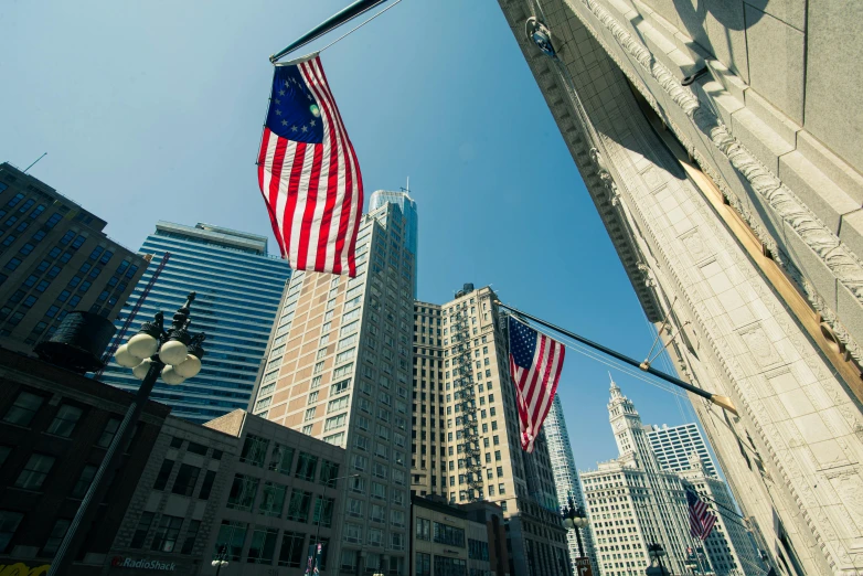 a group of american flags hanging from the side of a building, chicago skyline, high quality product image”, instagram picture, image