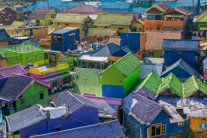 a group of colorful houses sitting on top of a lush green hillside, a colorized photo, pexels contest winner, sumatraism, fully covered in colorful paint, archipelago, jakarta, youtube thumbnail