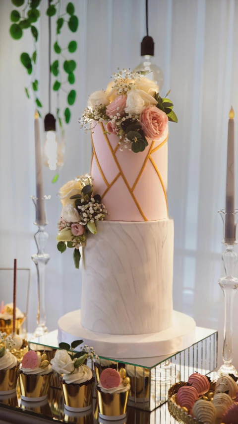 a wedding cake sitting on top of a table, a marble sculpture, by Robbie Trevino, pexels, pink marble building, thumbnail, seasonal, tall